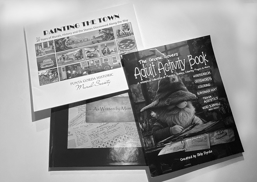 A black and white photo of three books created by Skip Dyrda